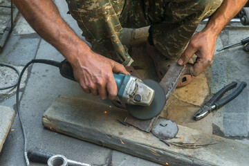 man welding electric steel with sparks and circular pipe