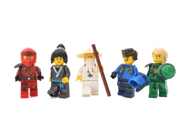 Naklejka premium Editorial illustrative image of lego ninjago minifugures green ninja Lloyd, water ninja Nia, sensei Wu, fire ninja Kai and blue ninja Jay isolated on white