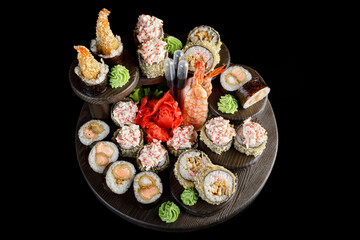 Sushi rolls in assortment on a black background