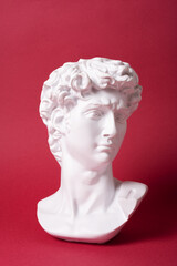 Bust of David's sculpture on a magenta colored background