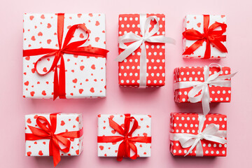 Valentine day composition Background: red gift box with bow and heart. Christmas present. View from...