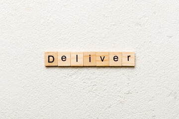 deliver word written on wood block. deliver text on table, concept