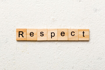 respect word written on wood block. respect text on table, concept