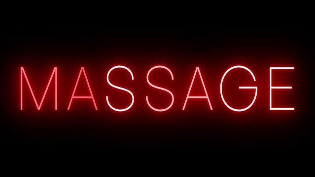 Retro red neon sign against a black wall with MASSAGE
