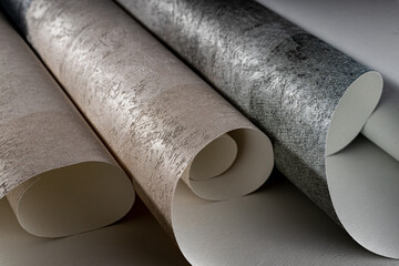 A roll of vinyl wallpaper with a beautiful paper texture in low light