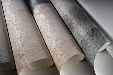 A roll of vinyl wallpaper with a beautiful paper texture in low light