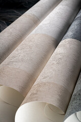 A roll of vinyl wallpaper with a beautiful paper texture in low light