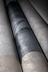 A roll of vinyl wallpaper with a beautiful paper texture in low light