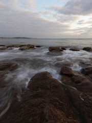 Rocky coastline and cloudy sky at Collaroy, Sydney, Australia.