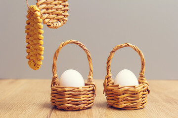 on a wooden table is a small decorative basket with one egg. Natural product. Spring Easter.