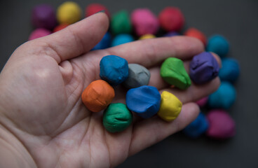 Colorful pieces of plasticine prepared for modeling in hands