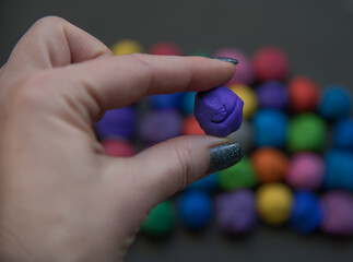 Colorful pieces of plasticine prepared for modeling in hands