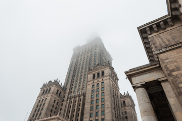Fototapeta na wymiar Vintage building Palace of Culture in Poland, Warsaw in the fog. Socialist Realism Architecture
