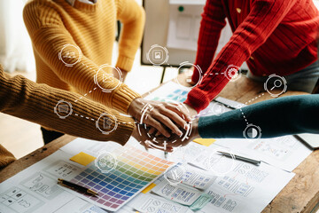 Close up view of UI developer team brainstorming on their project with laptop, smartphone and digital tablet. Creative digital development agency.