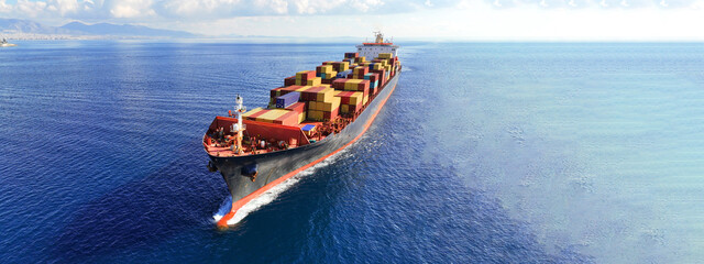 Aerial drone ultra wide photo over huge container tanker ship carrying truck size colourful...