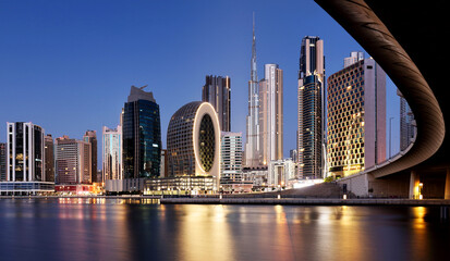 Obraz na płótnie Canvas Panaroma of Dubai skyline with Burj khalifa and other skyscrapers at night from Al Jadaf Waterfront, UAE