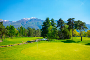 Fototapeta na wymiar Golf Course with Snowcapped Mountain in Ascona, Ticino, Switzerland