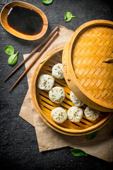 Delicious dumplings of manta with beef in a bamboo steamer.