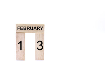 February 13 displayed wooden letter blocks on white background with space for print. Concept for calendar, reminder, date. 