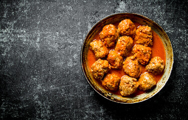 Meat balls in pan.