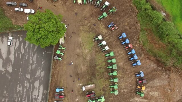 Aerial top view of new truck tractor cars parking for sale stock lot row, dealer inventory import and export business commercial