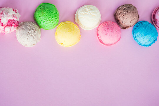 Colorful ice cream scoops on pink background