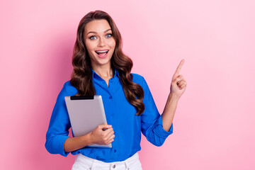 Photo of positive adorable lady wear blue stylish clothes arm presenting empty space offer proposition isolated on pink color background