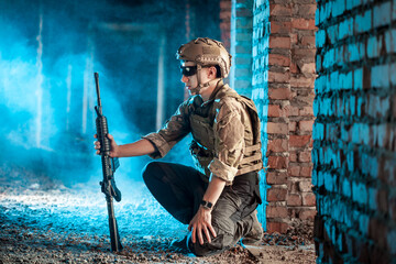 A soldier with a rifle in an abandoned building.