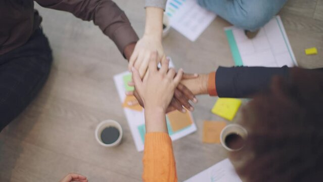 High-Angle Slow Motion Shot of Multi-Ethnic Hands Celebrating the Success of a Project