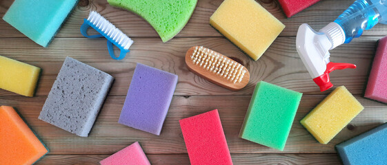 Kitchen cleaning sponge background with copy space. Flatlay. Assortment of section of household goods and chemicals in store. Hardware shop. Space for text. Banner or header for the site. Top view