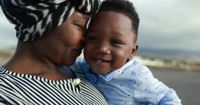 African mother having tender moment with little son outdoor - Mom day and family love concept