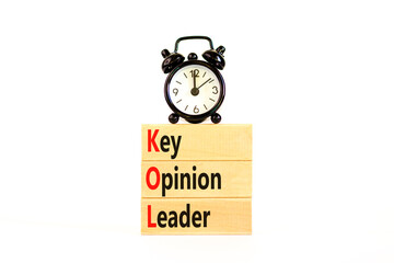 KOL key opinion leader symbol. Concept words KOL key opinion leader on wooden blocks on a beautiful white table white background. Black alarm clock. Business KOL key opinion leader concept. Copy space