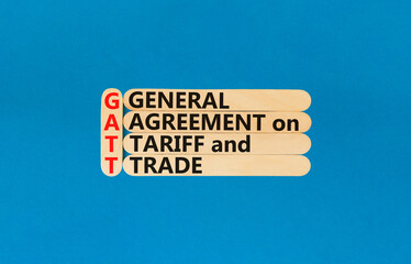 GATT symbol. Concept words GATT general agreement on tariff and trade on wooden stick on beautiful blue background. Business GATT general agreement on tariff and trade concept. Copy space.