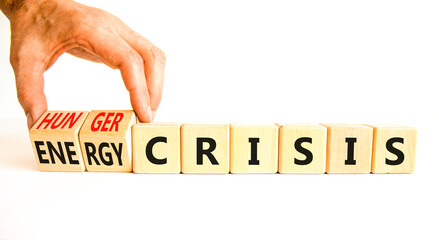 Energy or hunger crisis symbol. Concept word Energy crisis and hunger crisis on wooden cubes. Beautiful white background. Businessman hand. Business Energy or hunger crisis concept. Copy space.