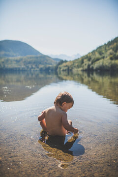 Baby boy playing in Hicks Lake, Harrison Hot Springs, British Columbia, Canada
