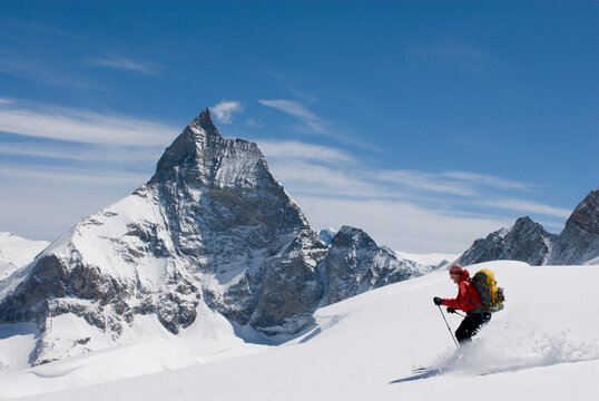 A young man skis the Stockji Glacier below the Matterhorn on the final day of the Haute Route ski traverse in Switzerland.