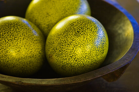 Green ostrich eggs in a hard wood bowl at Onguma tented camp on the Onguma Private Nature Reserve, Etosha National Park  - Namut