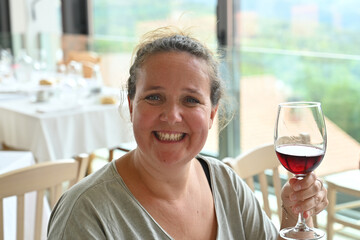 smiling young woman with a glass of red wine