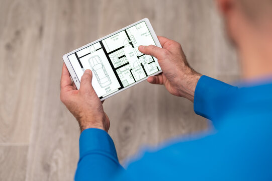 A businessman holds a tablet and works