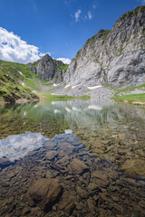 Beautiful nature. Mountain hiking Trail Road. Small mountain lake. Italy Lago Avostanis Casera Pramosio Alta