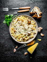 Fusilli pasta with mushrooms,mint leaves and Parmesan. © Artem Shadrin