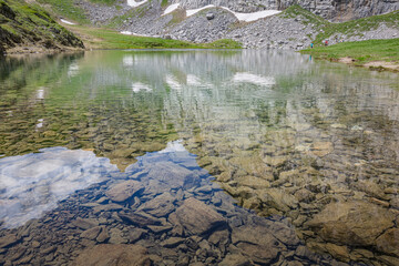 Beautiful nature. Mountain hiking Trail Road. Small mountain lake. Italy Lago Avostanis Casera Pramosio Alta