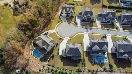 Aerial view upscale new development two story house with swimming pool and well trimmed yards near cul-de-sac of residential neighborhood suburbs Atlanta, Georgia, US