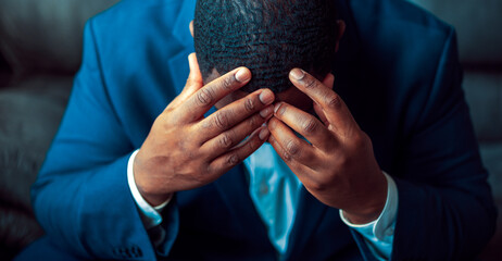 Black or African American business man sitting down looking anxious and depressed © rohane