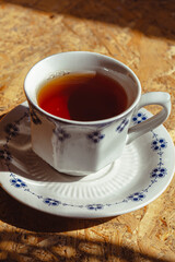 A cup of tea on vintage wooden background