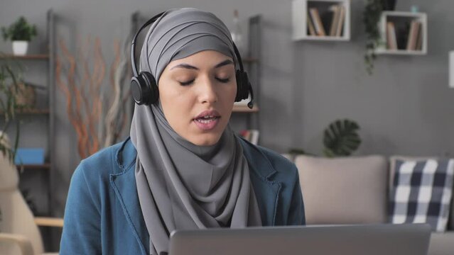 muslim female customer support service assistant working at computer giving remote assistance helping client,arab tutor coach training online