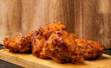 Chickens in spicy sauce fillet and breading in Asian style, spicy deep-fried chicken close-up, selective focus. Korean chicken.