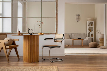 Interior design of open space interior with round table, rattan chair, window, vase with dried...