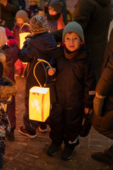 A little boy with a paper lantern at the Lantern Festival at the Waldorf School