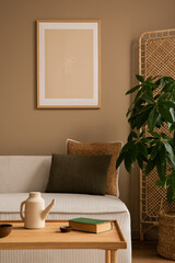 Creative composition of living room interior with mock up poster frame, beige modular sofa, brown...